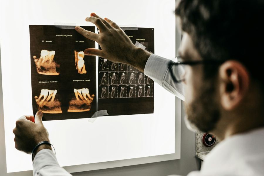 Orthodontist reviewing dental scans and treatment records